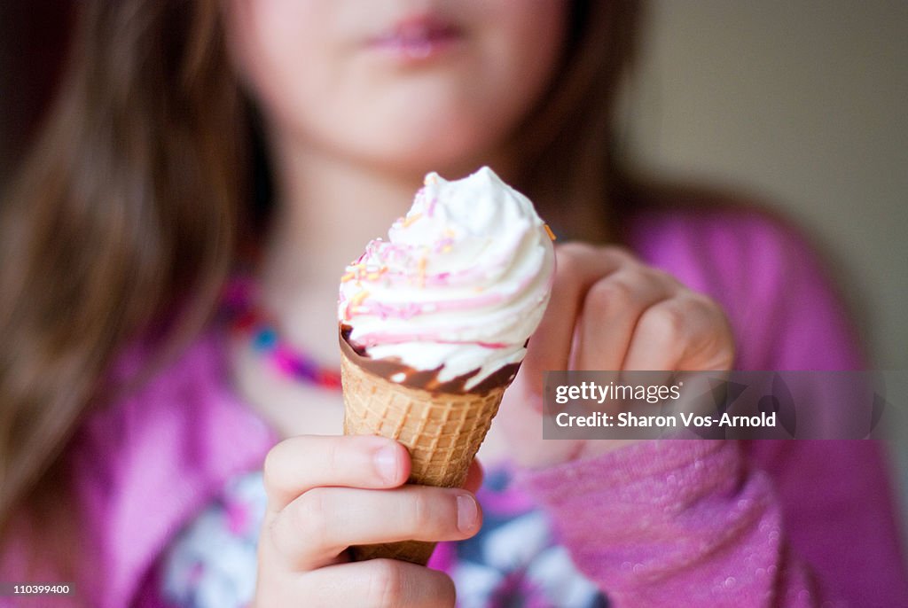 Girl holding and tasting an ice-cream