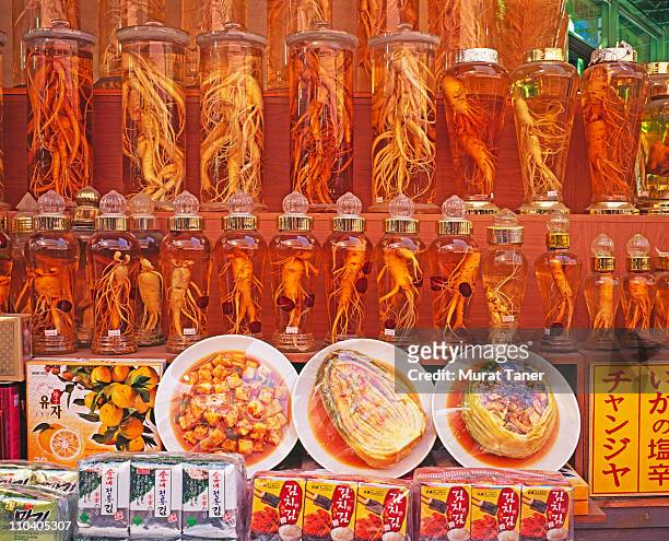 row of jars at a market - ginseng stock-fotos und bilder