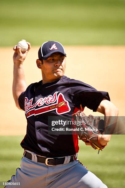 Pitcher Kenshin Kawakami of the Atlanta Braves pitches during a spring training game against the St. Louis Cardinals at Donald Ross Stadium on March...