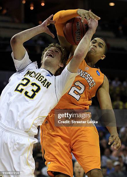Evan Smotrycz of the Michigan Wolverines and Tobias Harris of the Tennessee Volunteers battle for the ball in the first half during the second round...