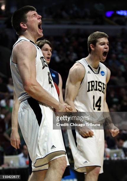 Notre Dame forward Jack Cooley, left, and Notre Dame guard Scott Martin react after Cooley scored while being fouled by Akron in the second round of...