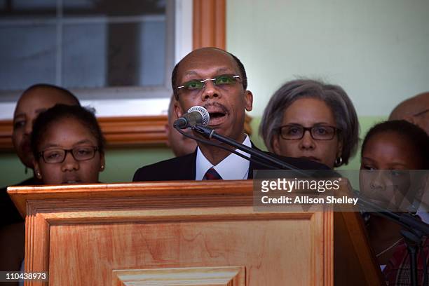 Surrounded by family and supporters, former Haitian President Jean-Bertrand Aristide speaks during a press conference after landing at the airport...