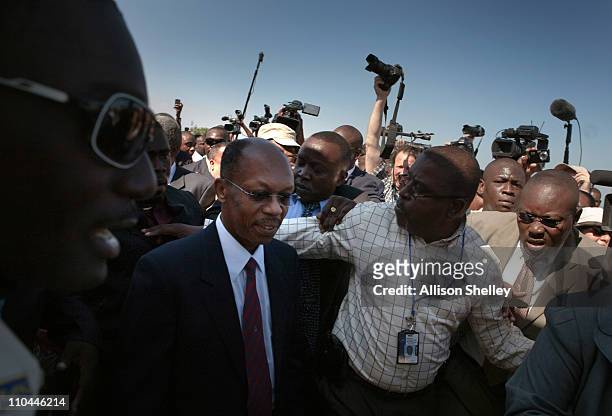 Former Haitian President Jean-Bertrand Aristide is escorted off of the tarmac at the airport March 18, 2011 in Port-au-Prince, Haiti. Aristide became...