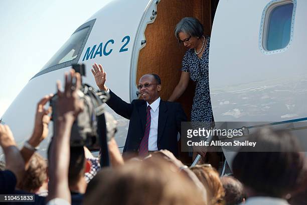 Former Haitian President Jean-Bertrand Aristide and his wife Mildred Trouillot disembark a private plane at the airport March 18, 2011 in...