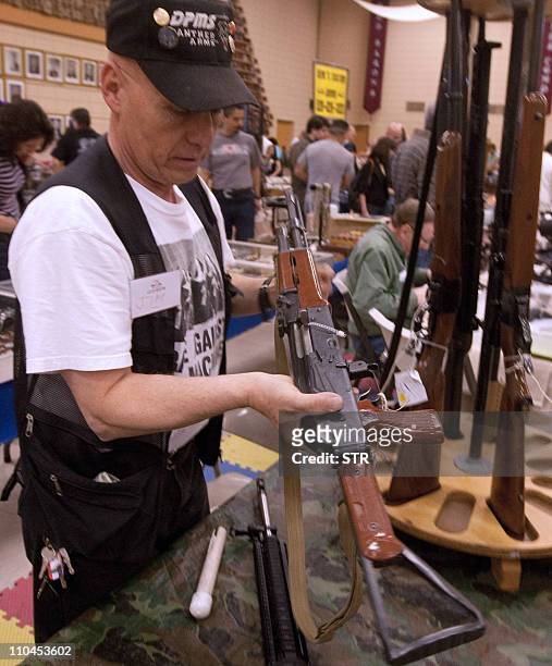 Customer holds a Chinese-made AKM Type 56 assault rifle at a gun expo in El Paso, Texas, USA, on March 13, 2011. The Mexican authorities think that...