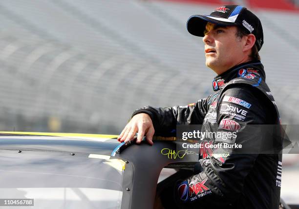 Jeff Gordon, driver of the Pepsi MAX Chevrolet, climbs from his car after qualifying for the NASCAR Sprint Cup Series Jeff Byrd 500 Presented By Food...