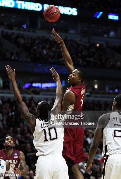 Florida State's Xavier Gibson shoots over Texas A&M forward David Loubeau during the first half of a second round game in the 2011 NCAA men's...