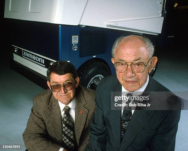 Ice resurfacing machine pioneers Frank Zamboni and his son Richard Zamboni with their Zamboni Ice Rink machine in background. The machine is used...