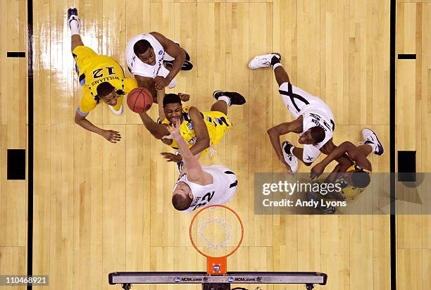 Davante Gardner of the Marquette Golden Eagles drives to the basket against Kenny Frease of the Xavier Musketeers during the second round of the 2011...