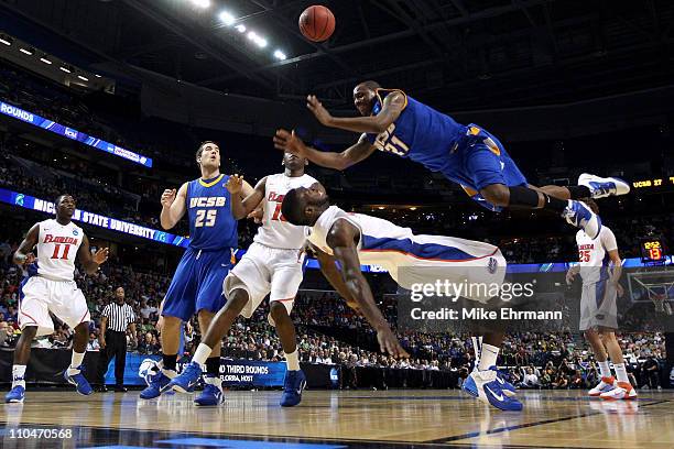 James Nunnally of the UC Santa Barbara Gauchos falls as he loses the ball driving against Patric Young of the Florida Gators in the second half...