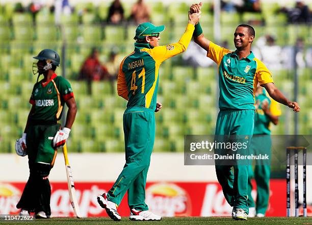 Robin Peterson of South Africa celebrates with team mates after taking the wicket of Shafiul Islam of Bangladesh caught by Graeme Smith during the...