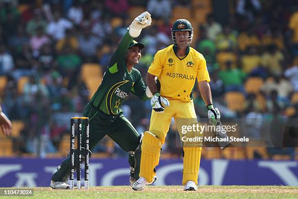 Ricky Ponting of Australia is caught behind by Kamran Akmal off the bowling of Mohammad Hafeez during the 2011 ICC World Cup Group A match between...