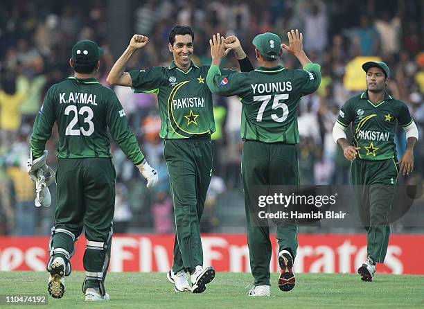 Umar Gul of Pakistan is congratulated by team mates after taking the wicket of Brett Lee of Australia to end Australia's innings during the 2011 ICC...