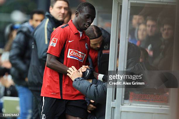 Papiss Demba Cisse of Freiburg celebrates a goal with team mate Kisho Yano during the Bundesliga match between SC Freiburg and Bayern Muenchen at...