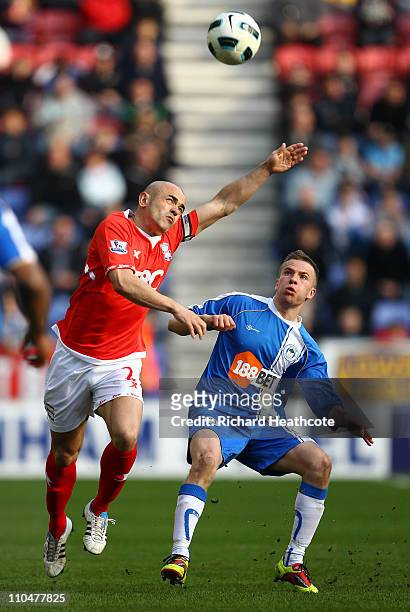 Tom Cleverley of Wigan is tackles Stephen Carr of Birmingham during the Barclays Premier League match between Wigan Athletic and Birmingham City at...