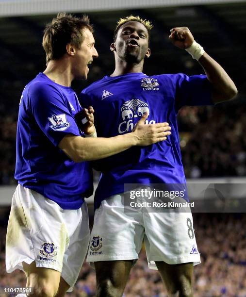 Louis Saha of Everton celebrates scoring his team's second goal with team mate Phil Jagielka during the Barclays Premier League match between Everton...