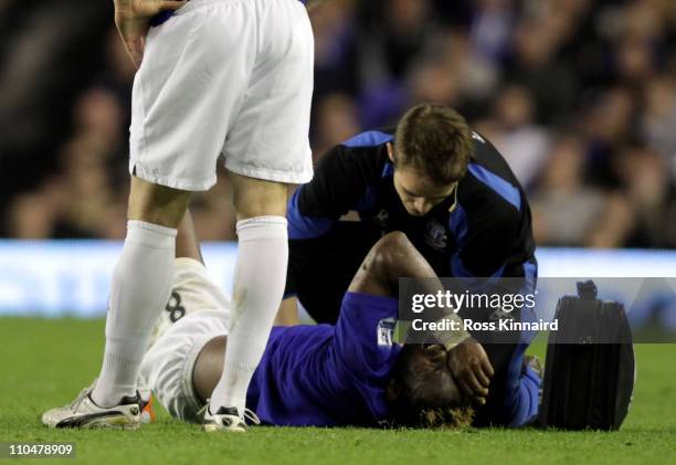 Louis Saha of Everton receives treatment on the pitch during the Barclays Premier League match between Everton and Fulham at Goodison Park on March...