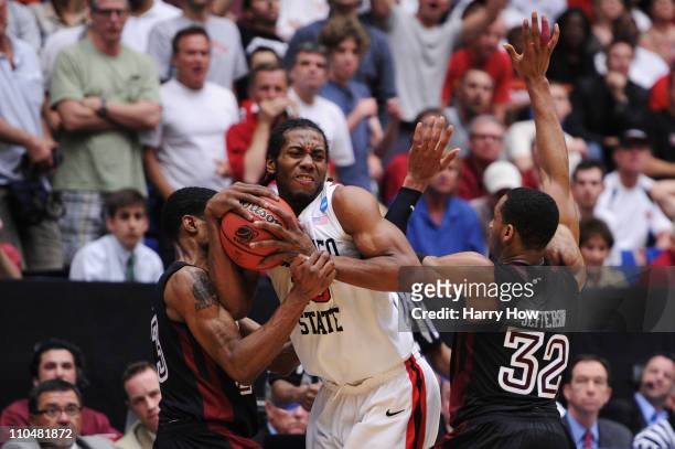 Ramone Moore and Rahlir Jefferson of the Temple Owls attempt to steal from Kawhi Leonard of the San Diego State Aztecs in double overtime during the...