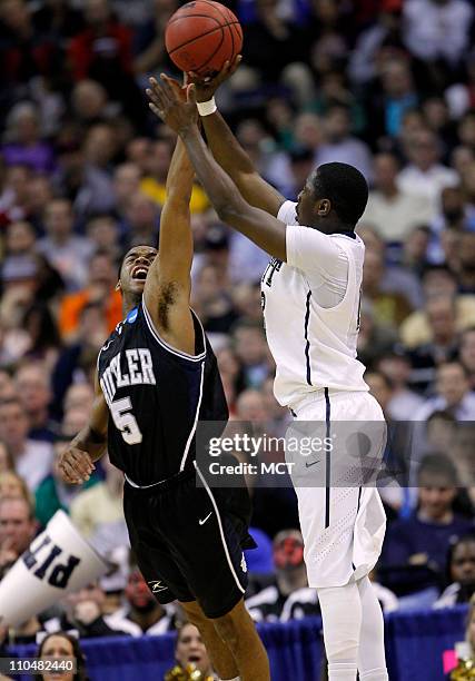 Butler guard Ronald Nored defends a shot attempt by Pittsburgh guard Ashton Gibbs during second-half action in the third round of the 2011 NCAA Men's...