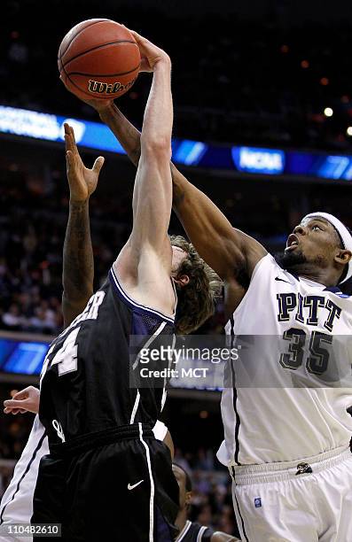 Butler forward Matt Howard , left, and Pittsburgh forward Nasir Robinson battle for the ball during second-half action in the third round of the 2011...