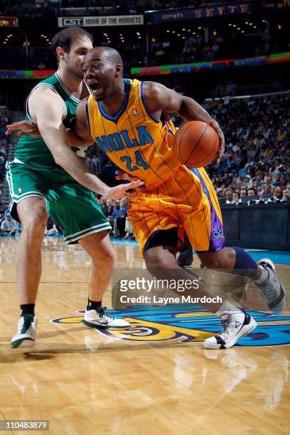 Carl Landry of the New Orleans Hornets drives against Nenad Krstic of the Boston Celtics on March 19, 2011 at the New Orleans Arena in New Orleans,...