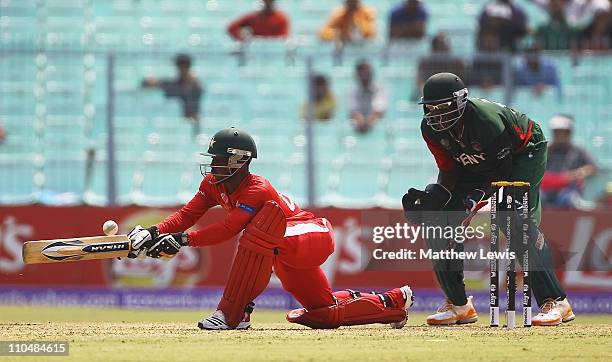 Tatenda Taibu of Zimbabwe plays a reverse sweep shot, as David Obuya of Kenya looks on during the ICC Wolrd Cup match between Kenya and Zimbabwe at...