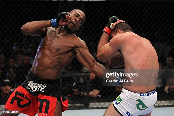 Jon Jones punches Mauricio "Shogun" Rua during their light heavyweight championship bout at UFC 128 at the Prudential Center on March 19, 2011 in...