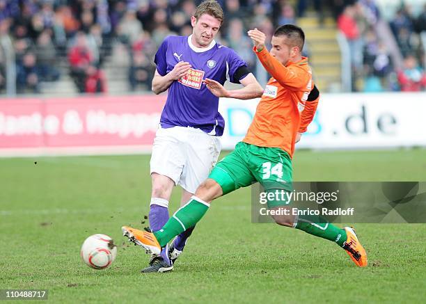 Pierre Le Beau of Erzgebirge Aue and Tayfun Pektuerk of Greuther Fuerth battle for the ball during the Second Bundesliga match between Erzgebirge Aue...