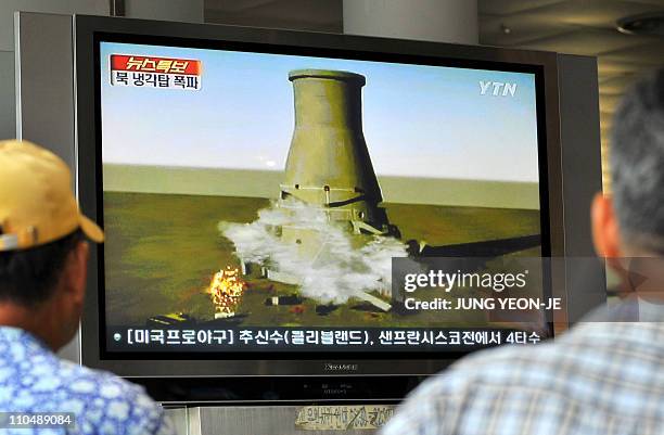 South Koreans watch a TV news programme at a railway station in Seoul, on June 27, 2008 that shows a mock video of the planned blow-up of a cooling...