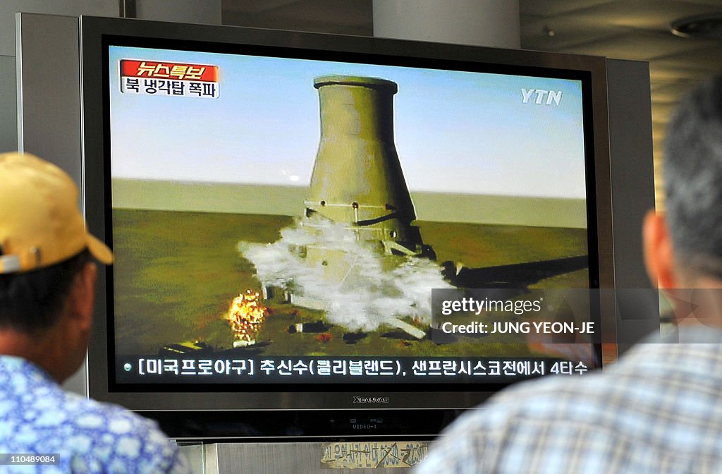 South Koreans watch a TV news programme