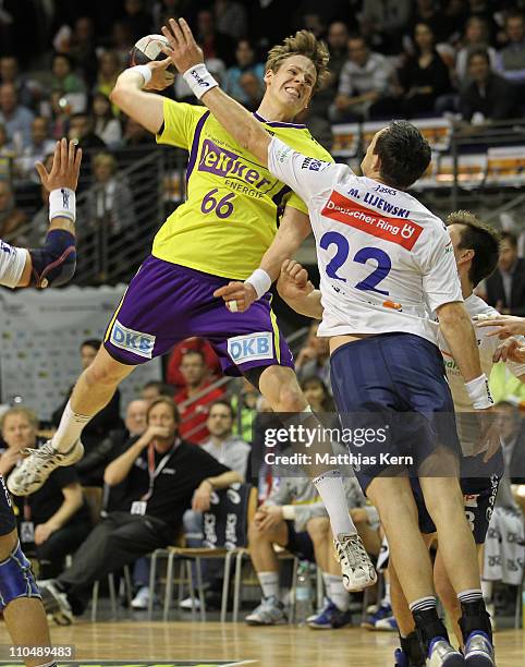 Sven Soerer Christophersen of Berlin is attacked by Marcin Lijewski of Hamburg during the Toyota Handball Bundesliga match between Fuechse Berlin and...