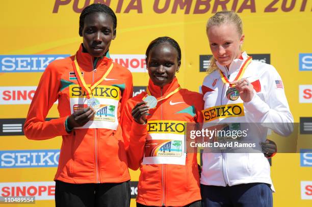 Vivian Jepkemoi Cheruiyot of Kenya poses with her gold medal after victory in Senior Women's race alongside silver medalist Linet Chepkwemoi Masai of...