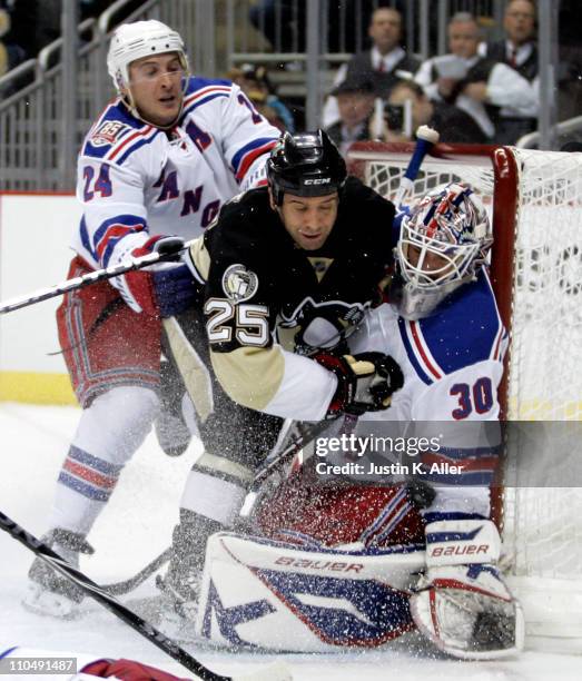 Henrik Lundqvist of the New York Rangers makes a save as Maxime Talbot of the Pittsburgh Penguins is checked by Ryan Callahan at Consol Energy Center...