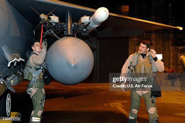 In this handout image provided by the U.S. Air Force, members of 492nd Fighter Squadron check on an F-15E Strike Eagle prior to their departure from...