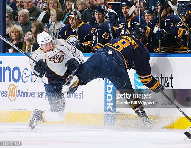 Cody McCormick of the Buffalo Sabres and Colin Wilson of the Nashville Predators collide into the boards at HSBC Arena on March 20, 2011 in Buffalo,...