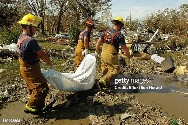 Members of the Biloxi Fire Department remove one of six bodies recovered at the Point Cadet area of Biloxi, Mississippi on Tuesday, August 30 the day...