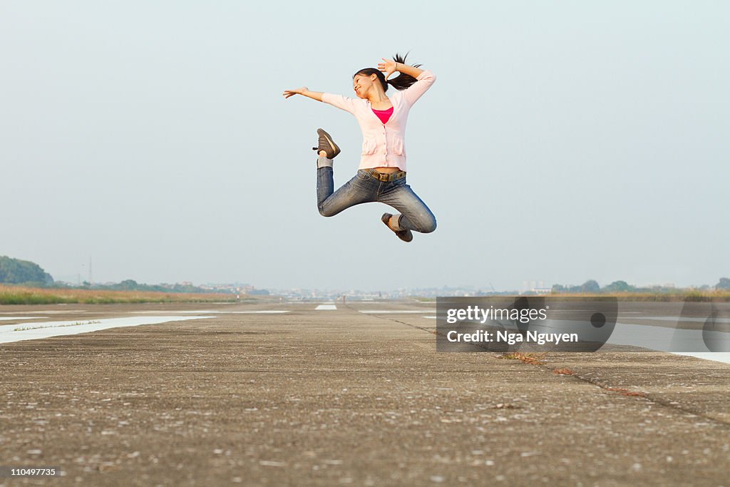 Excited young woman jumping
