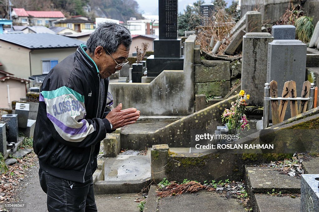 Katsuo Fujihara, 73, prays at the tomb o