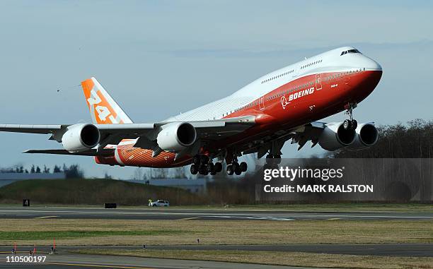 The 747-8 Intercontinental, Boeing's largest-ever passenger airplane, takes off for the first time from Paine Field in Everett, Washington state on...