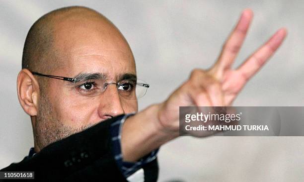 Seif al-Islam Kadhafi, son of Libyan strongman Moamer Kadhafi, flashes the V sign during a meeting with youths on March 10, 2011 in Tripoli, after he...