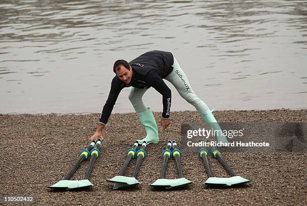 Cambridge's Australian rower Hardy Cubasch lays out the blades before the crew go out for a training session for the Xchanging 2011 Boat Race on The...