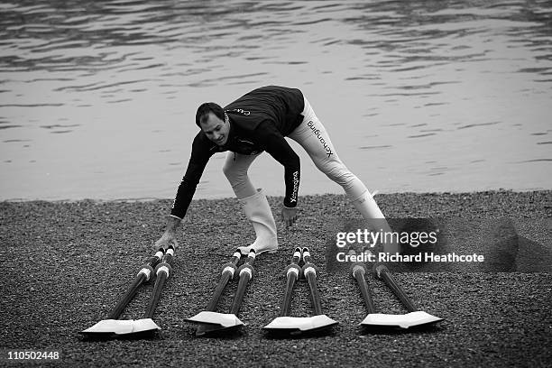 Cambridge's Australian rower Hardy Cubasch lays out the blades before the crew go out for a training session for the Xchanging 2011 Boat Race on The...