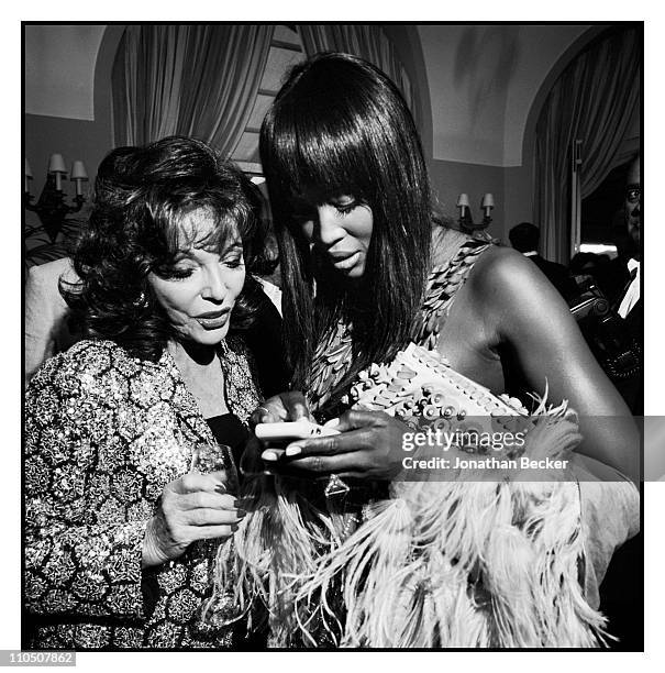 Actress Joan Collins and model Naomi Campbell are photographed at Vanity Fair Cannes Party at the Eden Roc, Cap d'Antibes for Vanity Fair Magazine on...