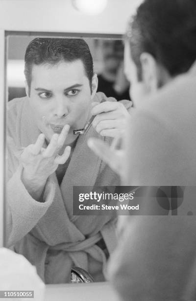 Queen frontman Freddie Mercury shaving his moustache, 12th April 1984.