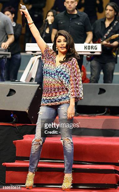 Lebanese pop star Haifa Wehbe performs during an event celebrating mother's day in Beirut on March 21, 2011. AFP PHOTO/STR