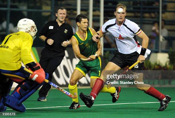 Florian Kunz of Germany is challenged by Jamie Dwyer of Australia during the World Cup Hockey final between Germany and Australia held at the Bukit...