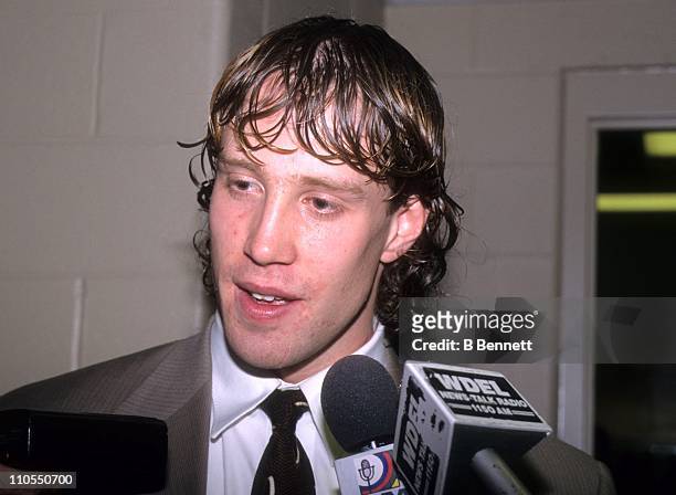 Joe Thornton of the Boston Bruins talks with the press after scoring his first NHL goal during the game against the Philadelphia Flyers on December...
