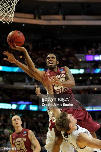 Derwin Kitchen of the Florida State Seminoles shoots against Tim Abromaitis of the Notre Dame Fighting Irish in the second half during the third...