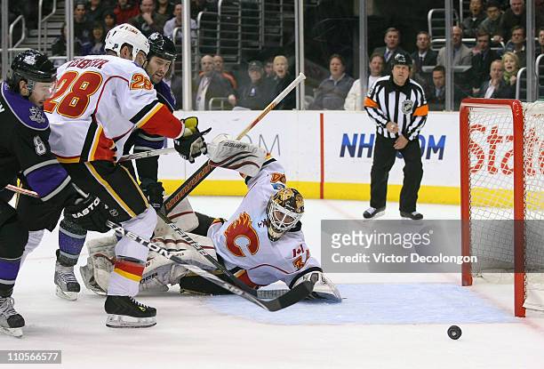 Goaltender Miikka Kiprusoff of the Calgary Flames watches as the puck goes wide of the net in the second period during the NHL game against the Los...