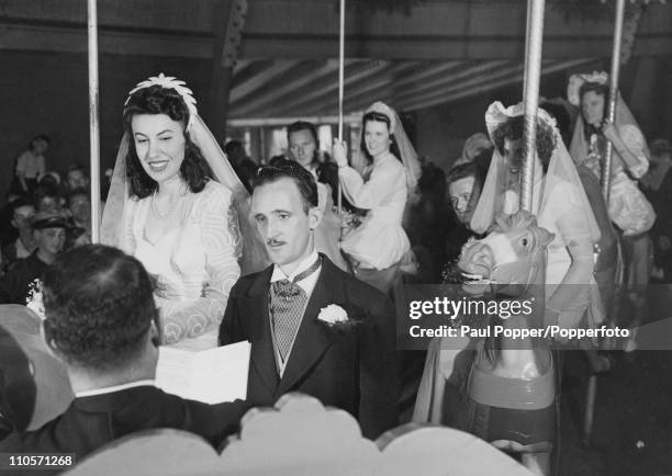 The wedding ceremony of Ann Monaco and Alfred J Schiebel on a carousel at the Palisades Amusement Park, New Jersey, June 1946. The couple first met...
